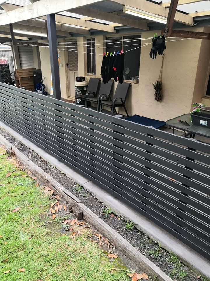 Commercial painting of exterior fence and patio area with modern finish